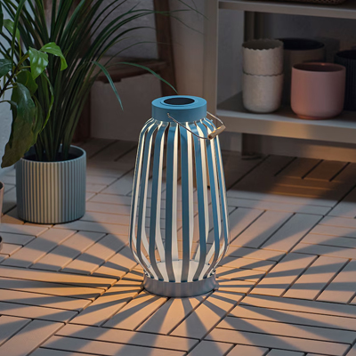 Blauwe, staande buitenlamp op een terras.